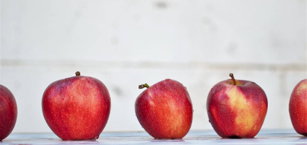 Five red apples. Photo by Isabella and Zsa Fischer on Unsplash.