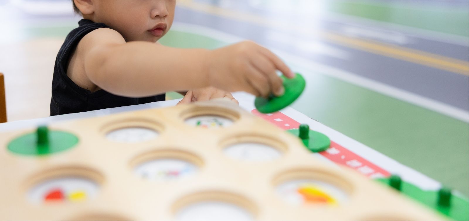 A boy aged about 2 playing with wooden blocks.