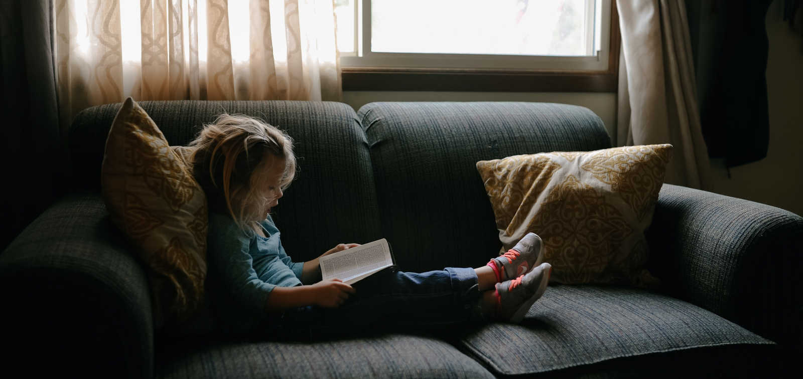 Girl reading in the sofa