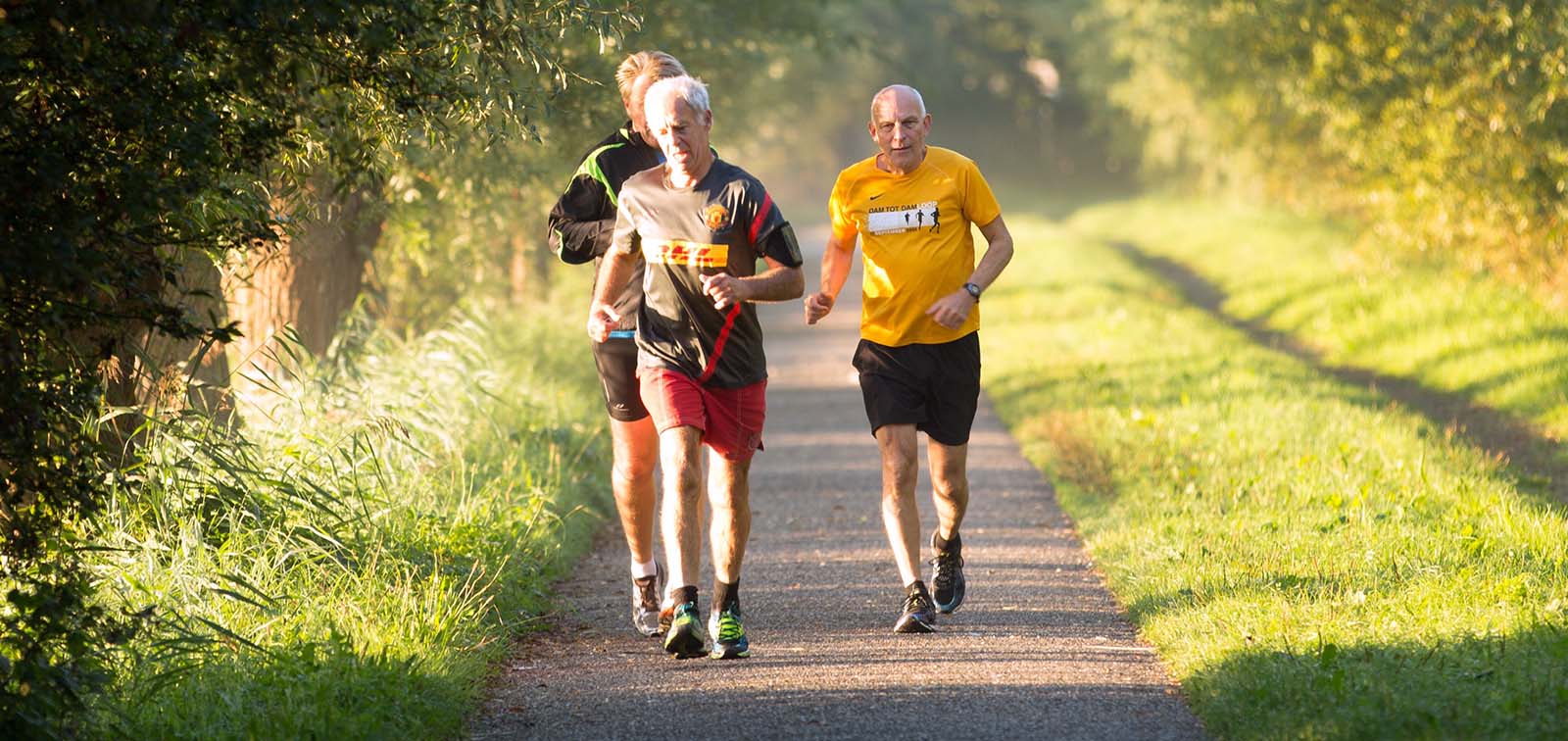 Three old men running in the park